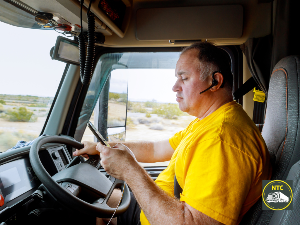 truck driver texting at the wheel, a common cause of truck accidents